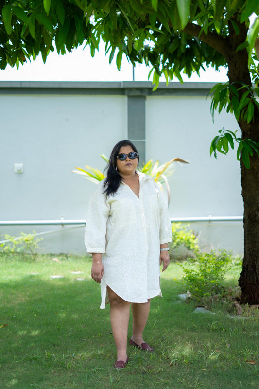 Woman in a white buttondown dress, model is wearing size 4XL
