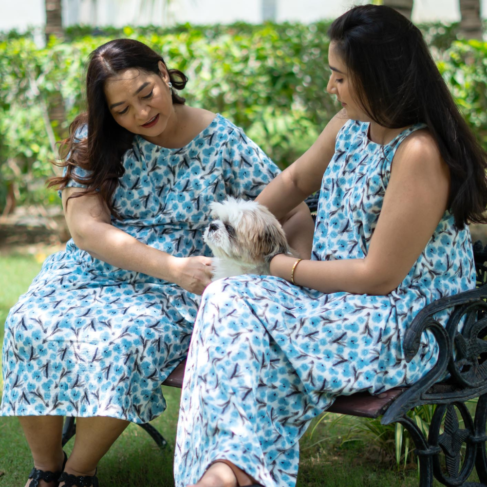 Model wearing size 3XL midi dress with a bow at back and another wearing boat-neck sleeveless maxi dress